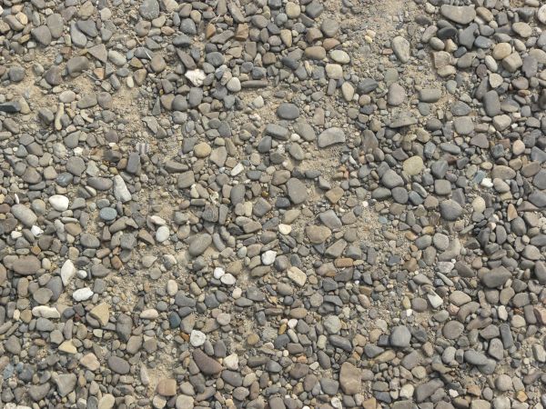 Gravel texture consisting of stones of various colors with smooth, round surfaces.